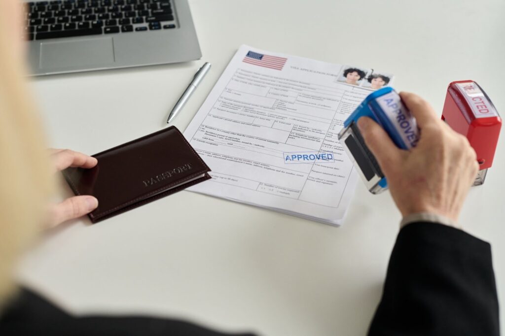 An immigration office worker approving a visa application.