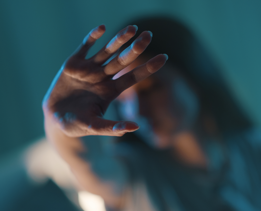 Violence Against Women Act. Woman with her hand pushed forward and blurred out.