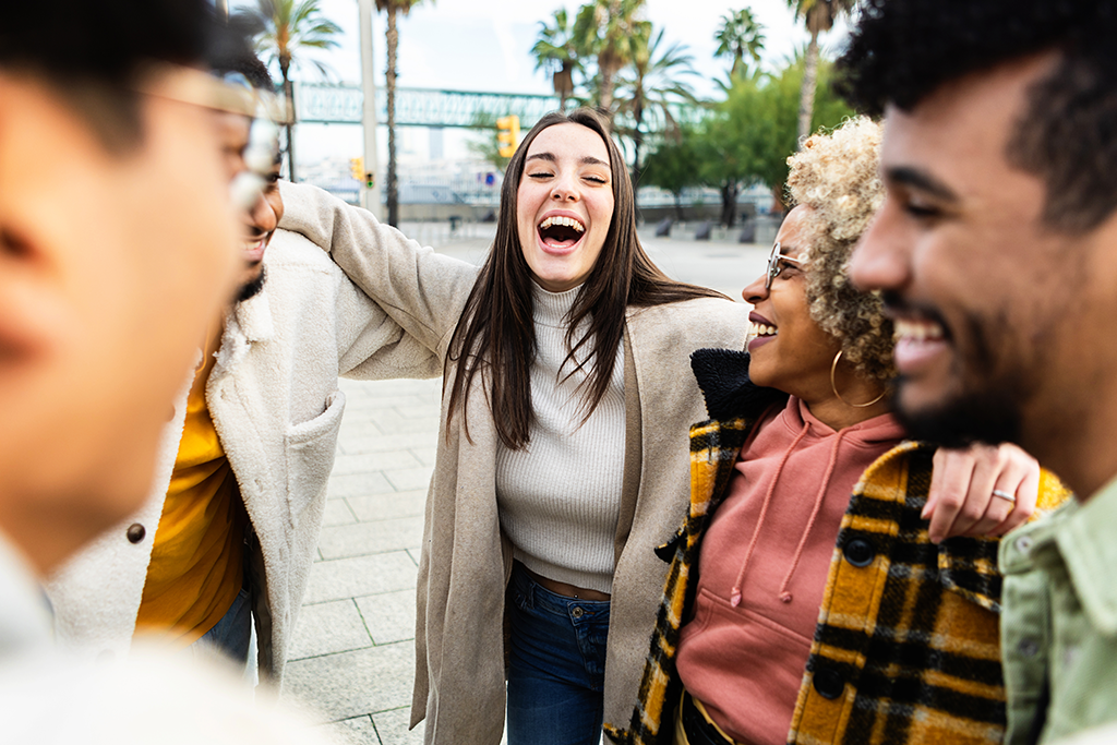 A woman in the center talking to a group of diverse people