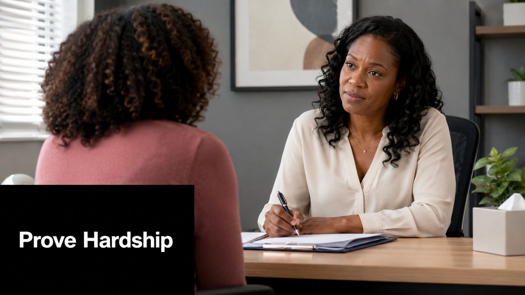 A professional woman in a white blouse listens attentively to a client during a formal consultation session.